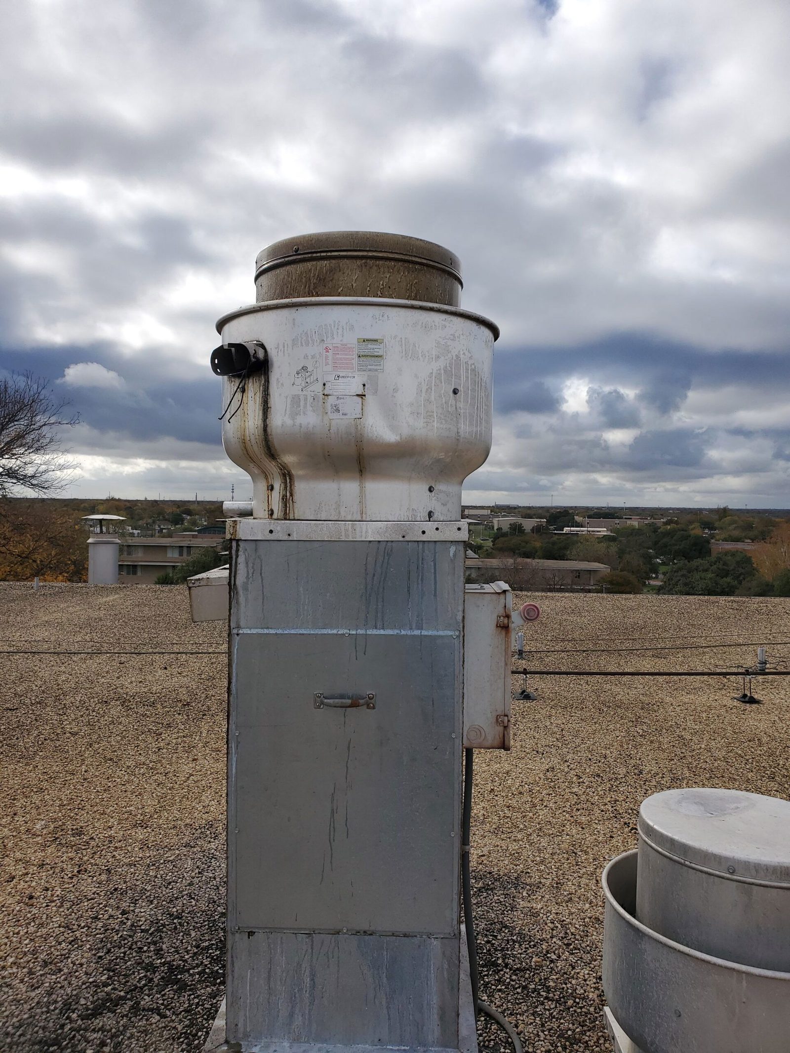 Rooftop kitchen exhaust fan before cleaning