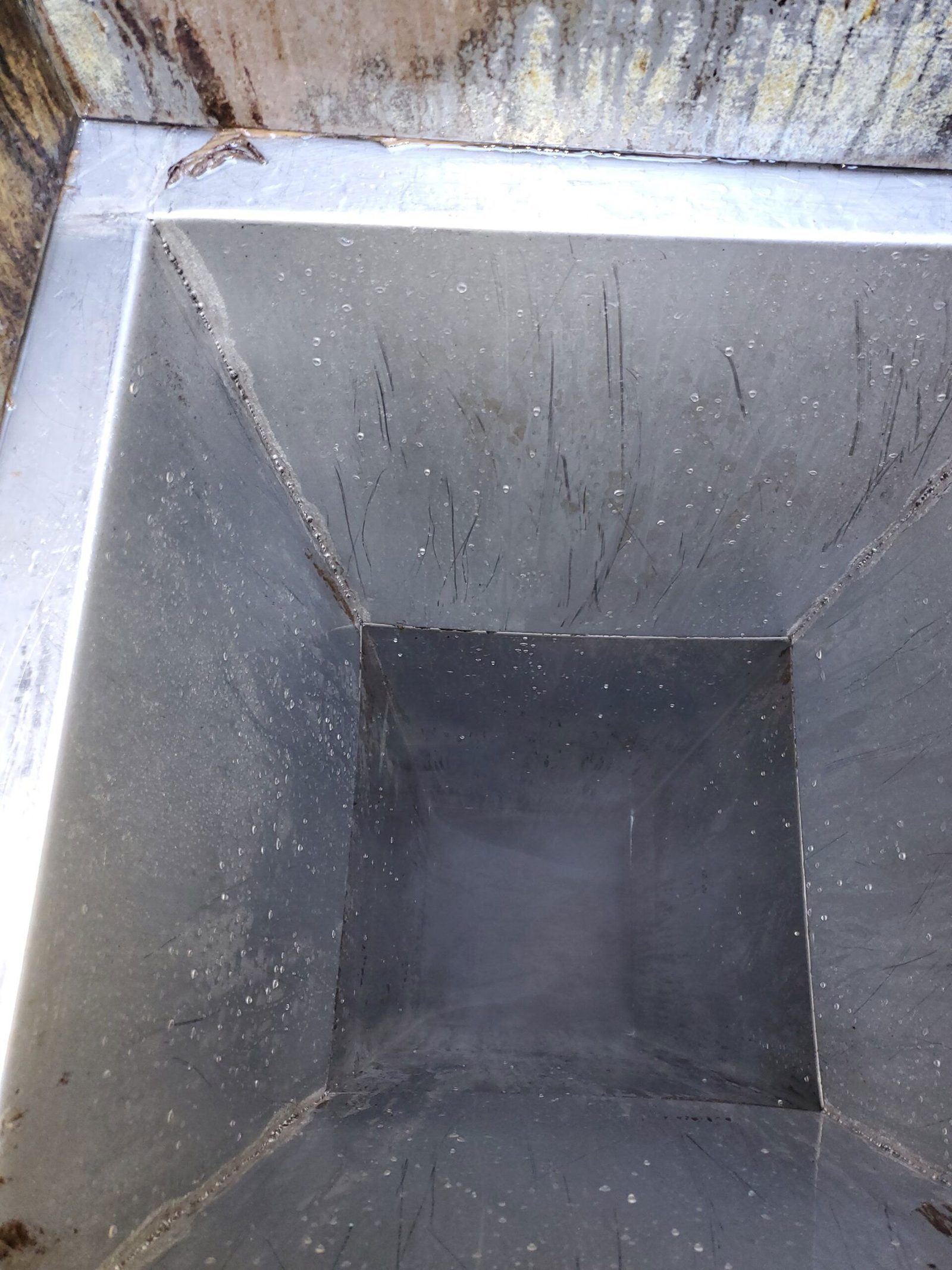 Exhaust duct riser cleaned to bare metal