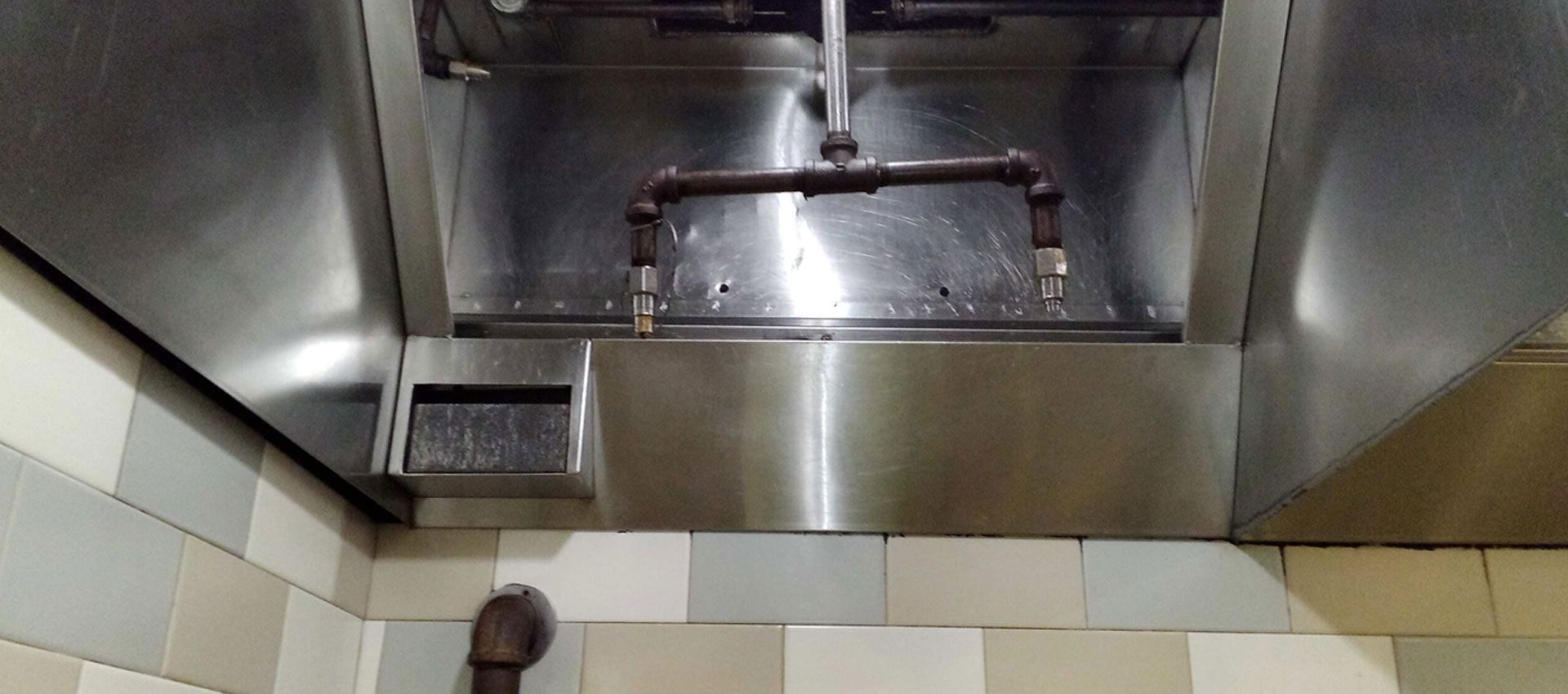 Commercial kitchen exhaust hood cleaned to bare stainless steel