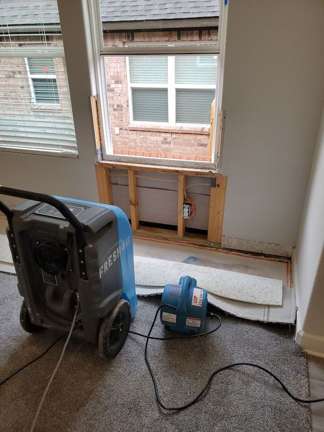 Dehumidifier under a window with the wall opened for drying