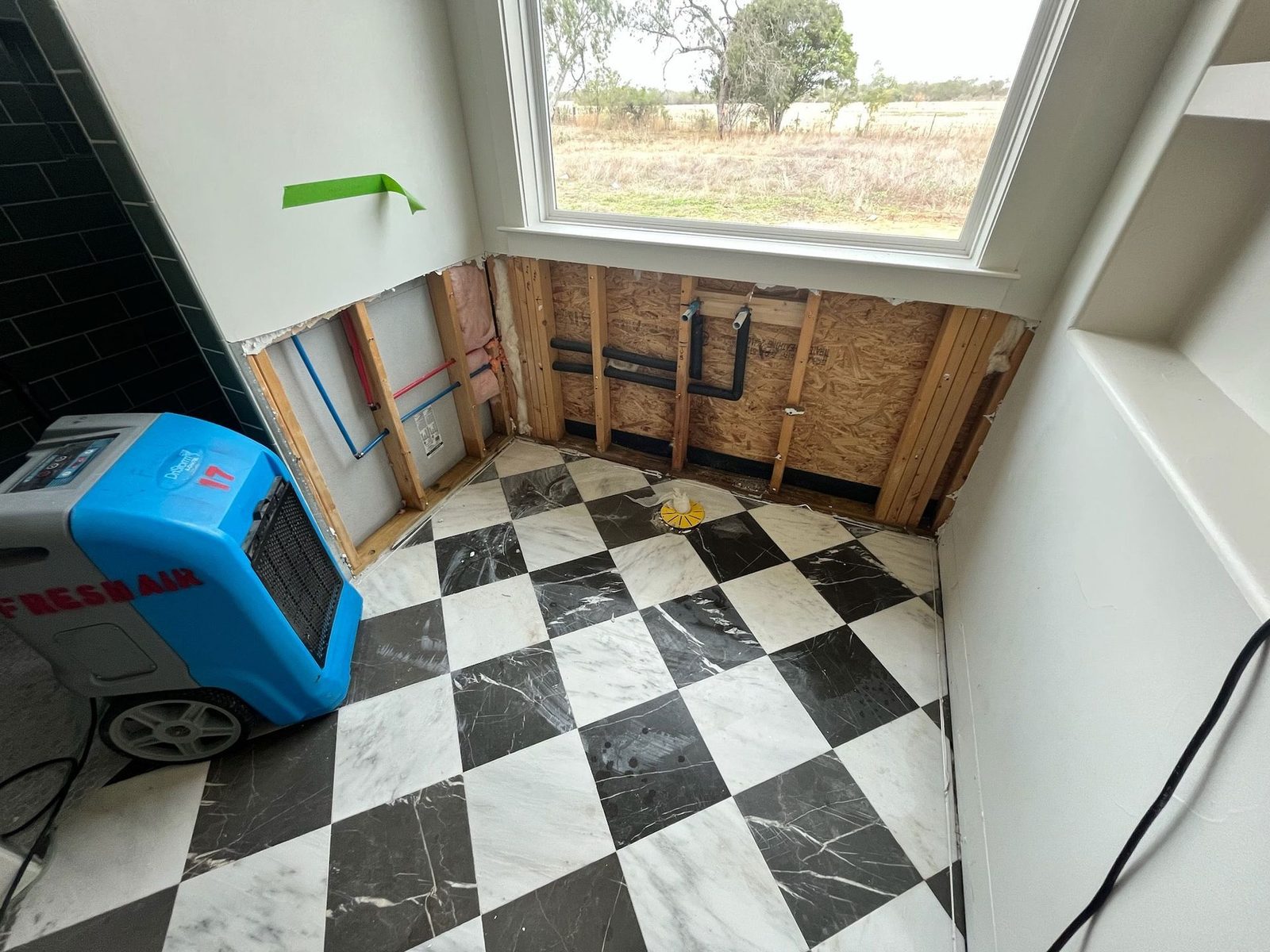 Bathroom stripped to the studs and drying after a water loss